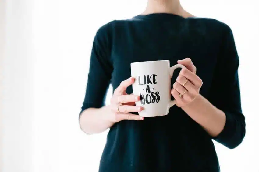 woman holding a mug that says “like a boss"