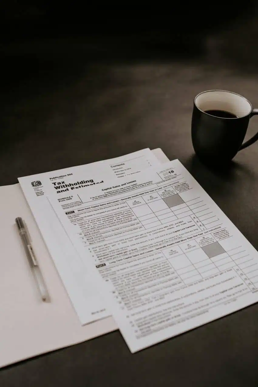 Tax documents with a pen and cup of coffee